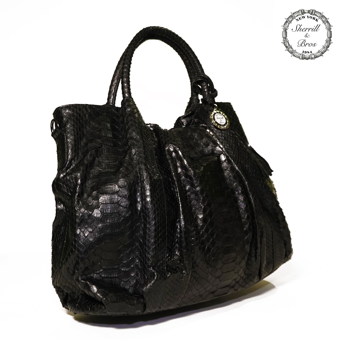 side view of black python skin handbag with handles