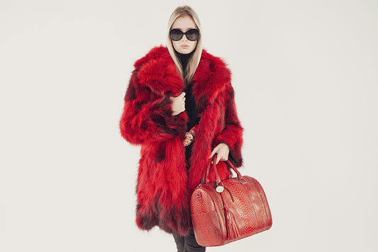 Model Wearing A Red and black raccoon fur coat 