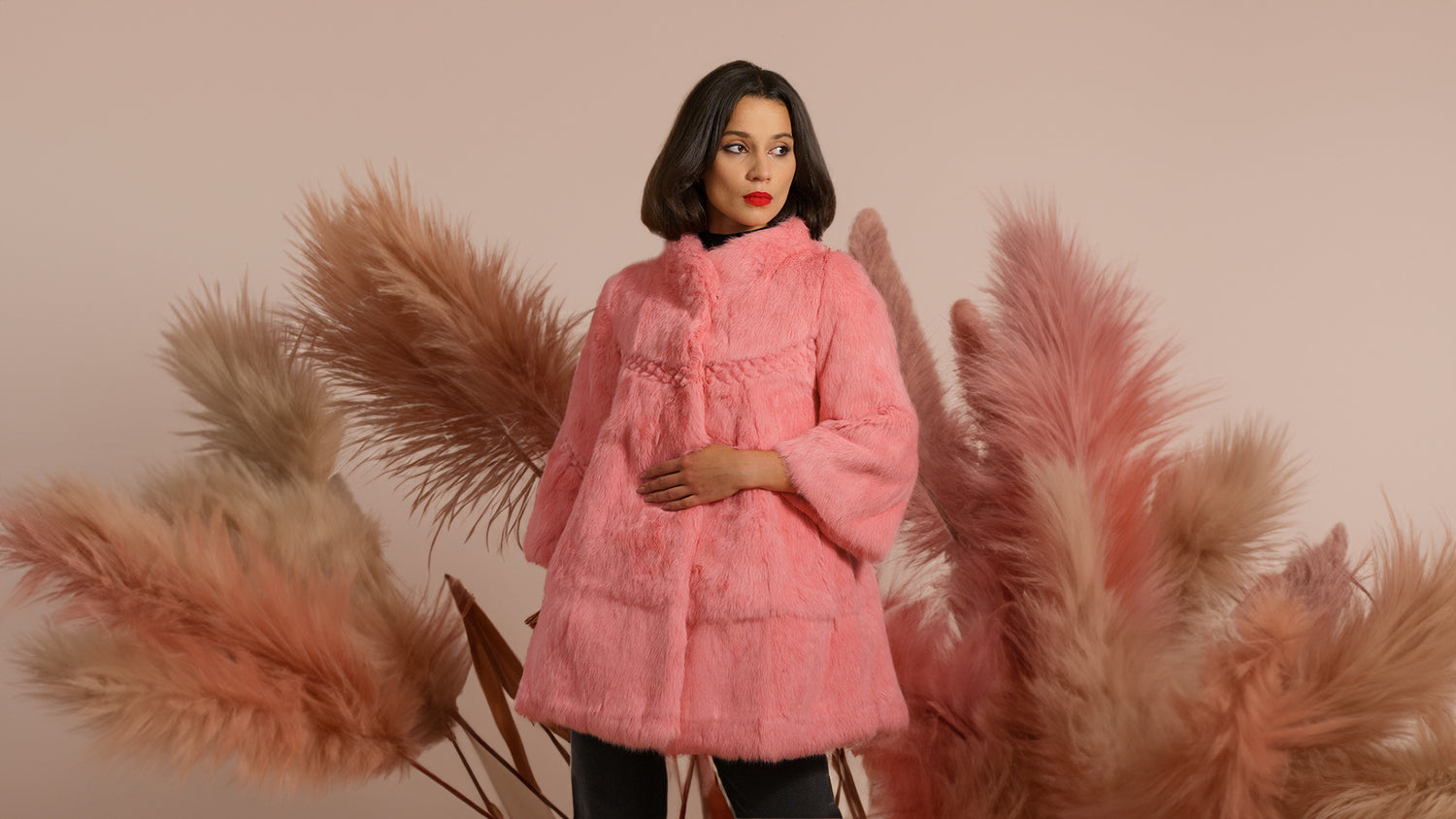 model wearing a pink genuine fur coat from sherrill bros