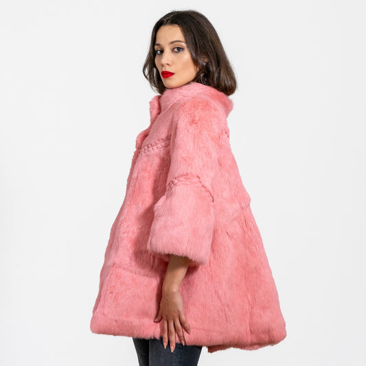 side view of a real fur coat for women in pink 