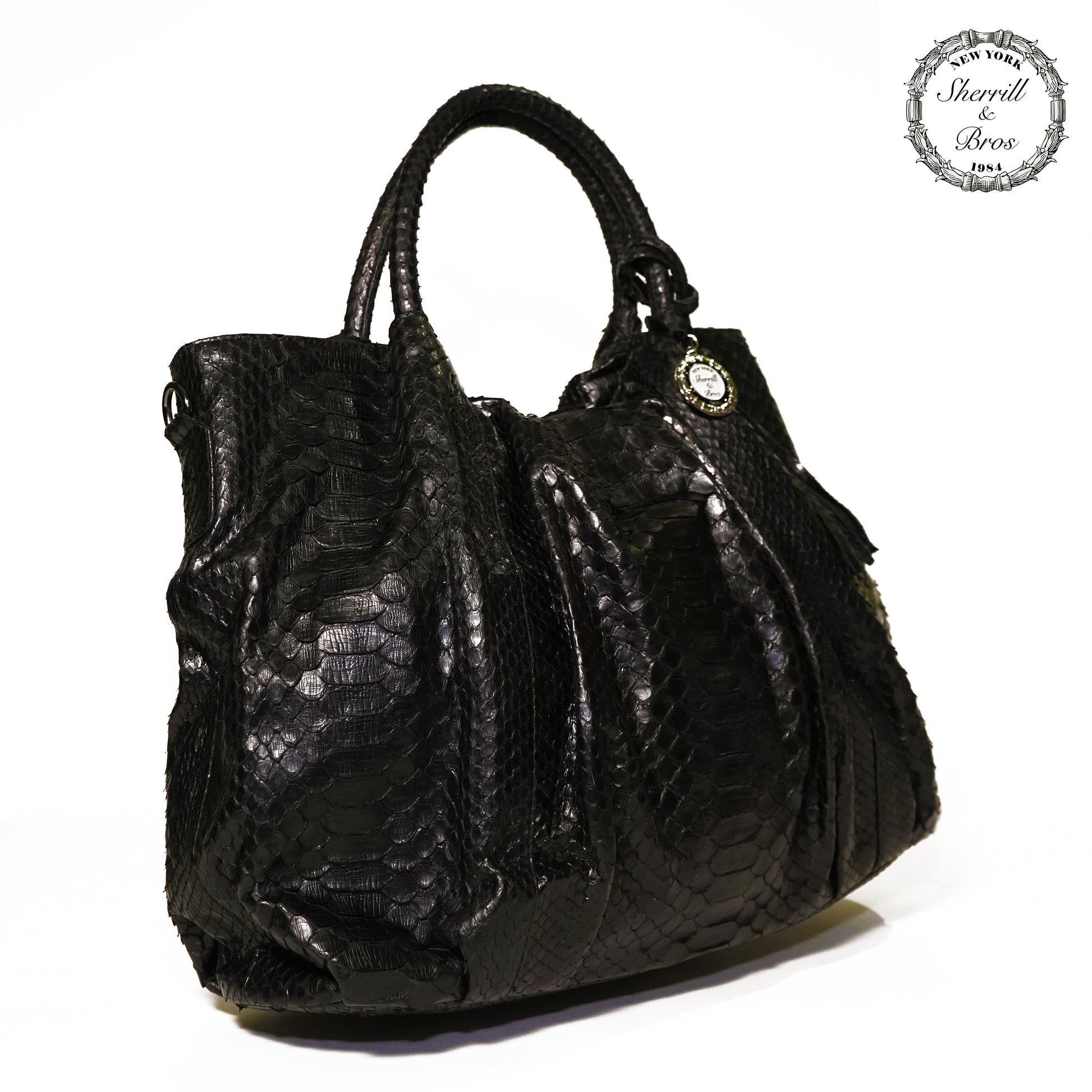 side view of black python skin handbag with handles 