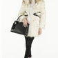blonde model wearing a fur coat and carrying the sherrill brothers black python tote bag  